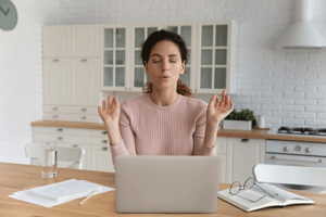 Woman practices techniques learned in anger management program while reading stressful email