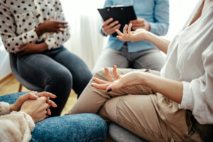 Hands of people in a group therapy program