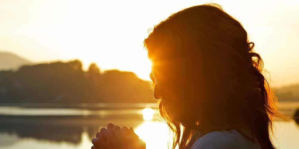 a woman folds her hands as she considers panic disorder treatment