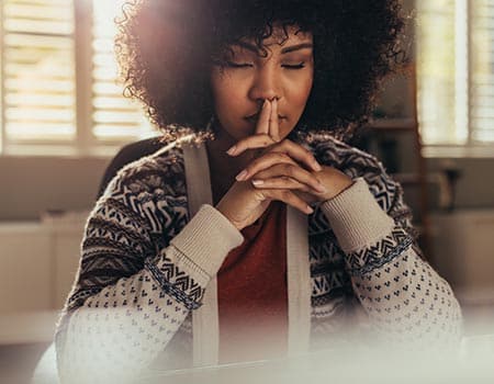 a woman meditates momentarily as she considers true life center