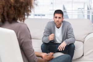 male patient consults with female therapist during meth addiction treatment program