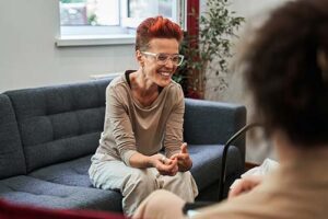 Woman smiles while talking to therapist about neurodivergence