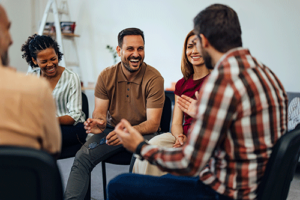 People bond and laugh during group therapy while in painkiller addiction treatment