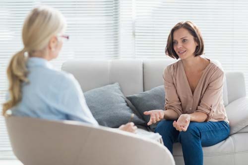 professional talking about a cognitive-behavioral therapy program with a patient